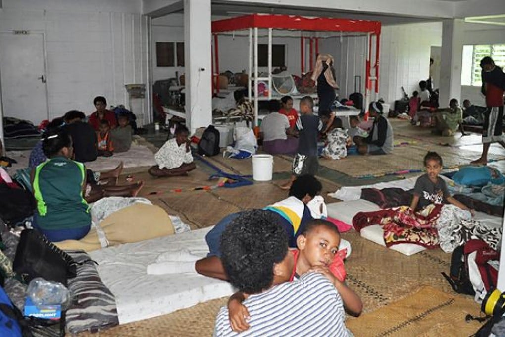 Residents take shelter at an evacuation centre in Suva. Photo: AFP