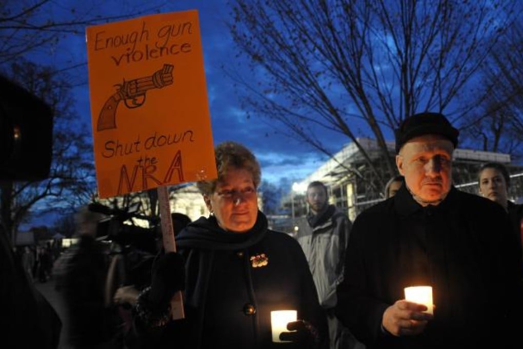 Gun control supporters in a candlelight vigil in Washington after twenty-seven people were killed in Newtown, Connecticut. Photo: AFP