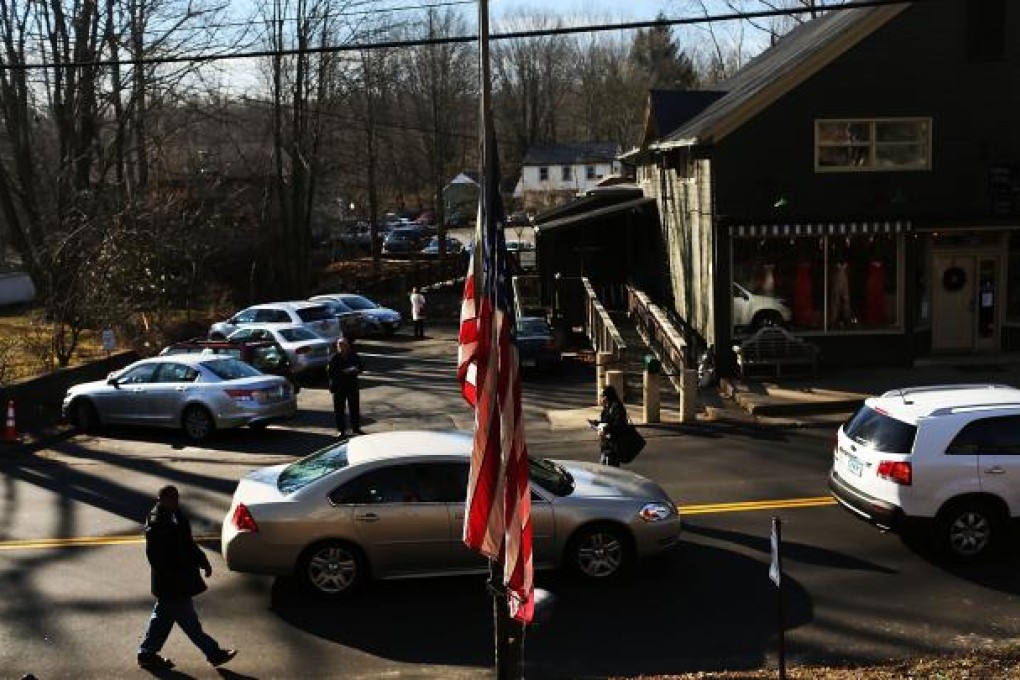 Connecticut community copes with aftermath of the mass shooting. Photo: AFP