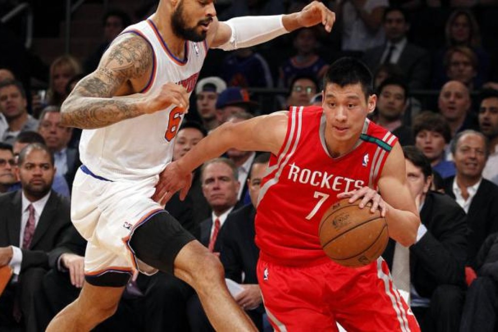 Point Guard Jeremy Lin takes on New York Knicks' centre Tyson Chandler in the first quarter of the game. Photo: Reuters