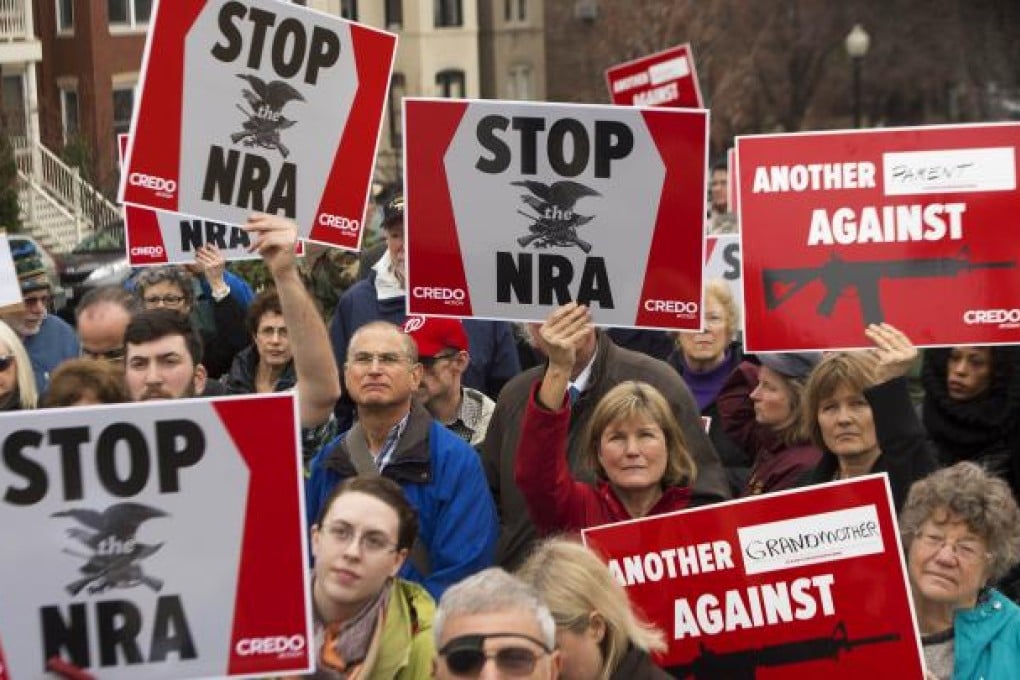 Protesters demand the National Rifle Association stand down in reaction to the shooting. Dianne Feinstein, the influential chair of the Senate Intelligence Committee, said she believed President Barack Obama would support her legislation. Photo: AFP