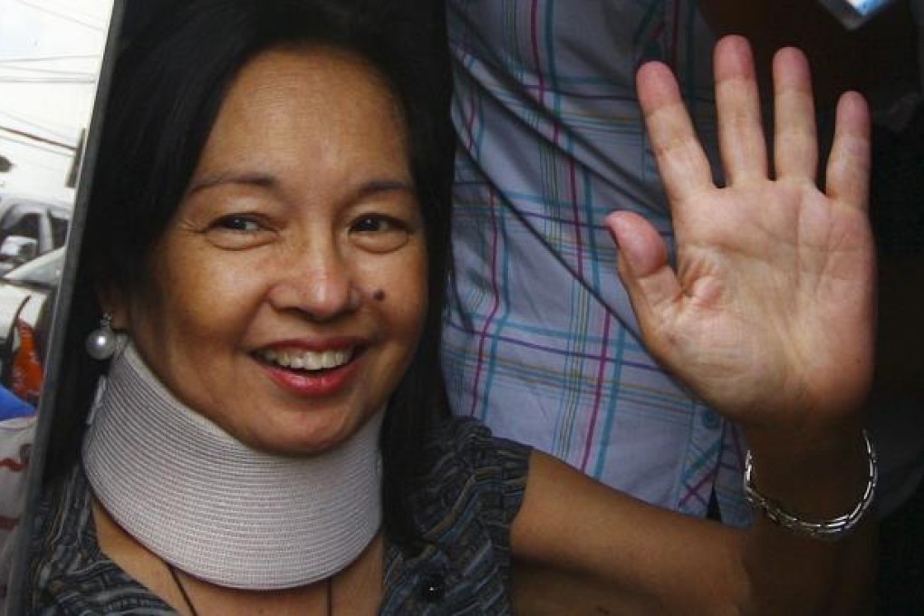 Gloria Arroyo waves to her supporters in Quezon. Photo: Reuters