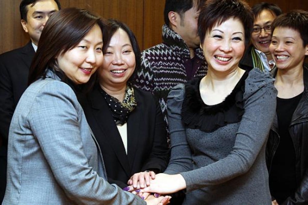 (Left to right) Liza Ng, Cathay Pacific General Manager Cabin Crew; Melody Luk Wai-ling, Chief Labour Officer of the Labour Department; and Cathay Pacific Flight Attendants' Union chairman Dora Lai Yuk-sim shake hands after reaching a deal on working arrangements.  Dickson Lee
