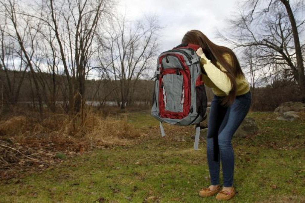 A woman shows how to use a bulletproof pack. Photo: Reuters