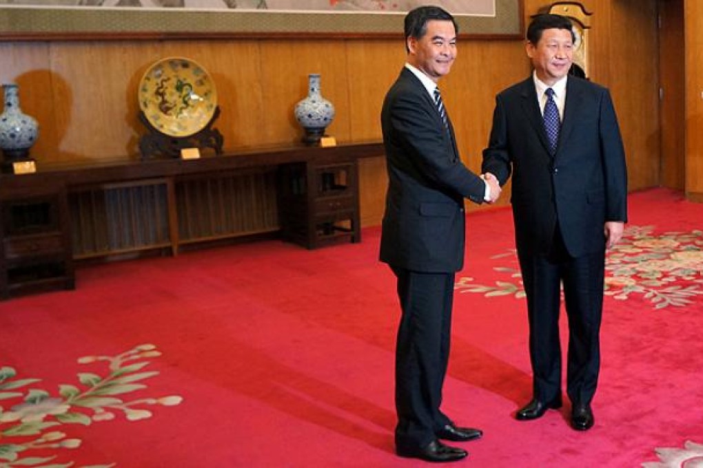 CY Leung shakes hands with Communist Party leader Xi Jinping in Beijing. Photo: SCMP Pictures