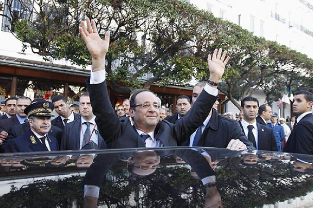 French President Francois Hollande waves to crowds in Algiers. Photo: Reuters