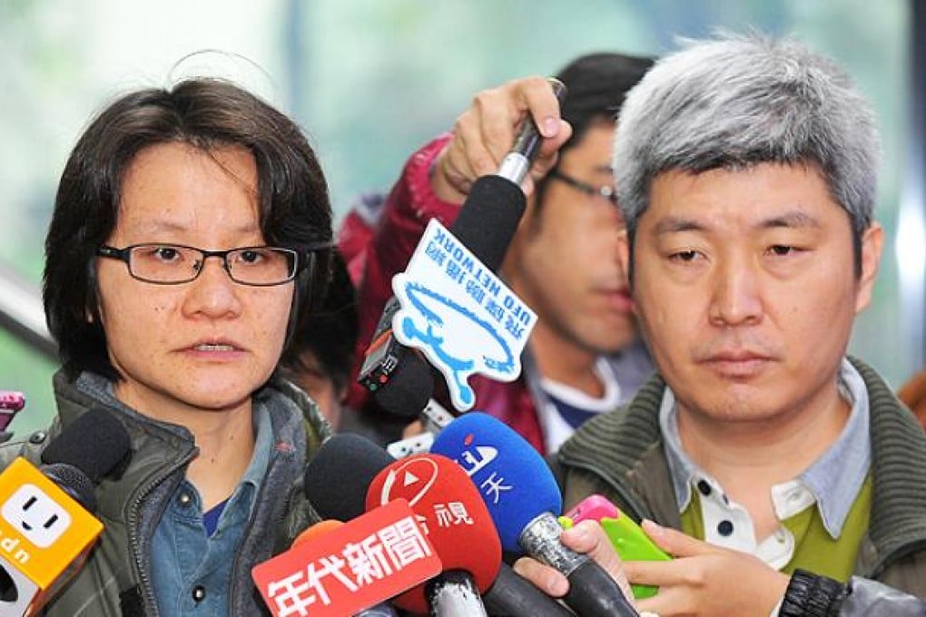 Rights activist Shawn Wu (left) speaks while activist Ho Tsung-hsun looks on during a press conference about a court ruling on gay marriage on Thursday. Photo: AFP