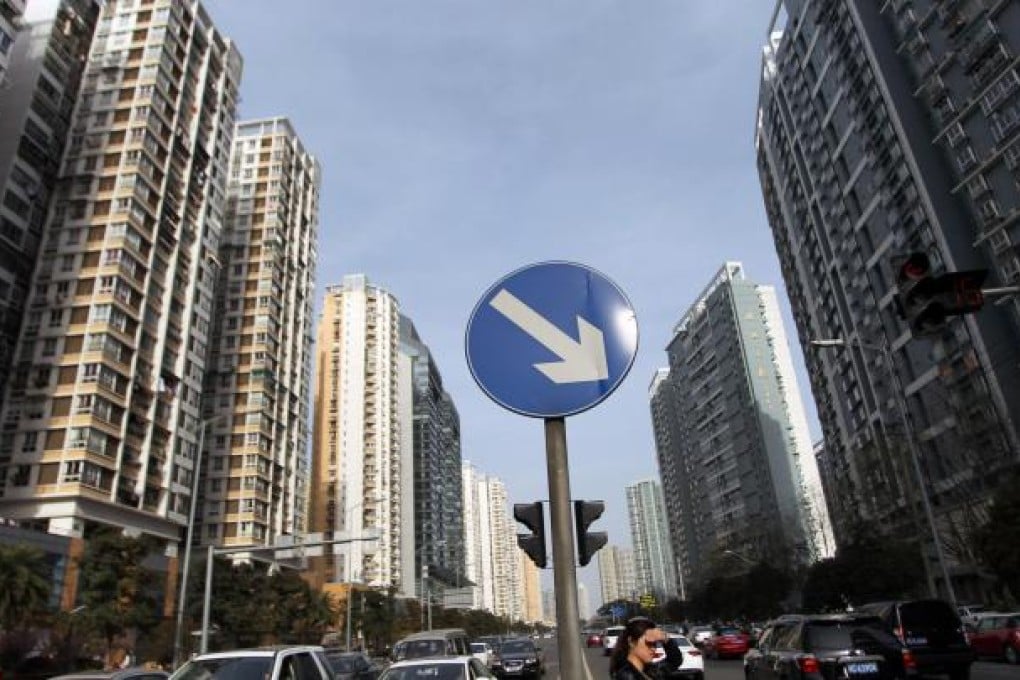 Residential buildings line a major street in Wenzhou, Zhejiang province. Only two years ago, the city's property market was the hottest on the mainland, but it has fallen on hard times after government cooling measures. Photo: Imaginechina