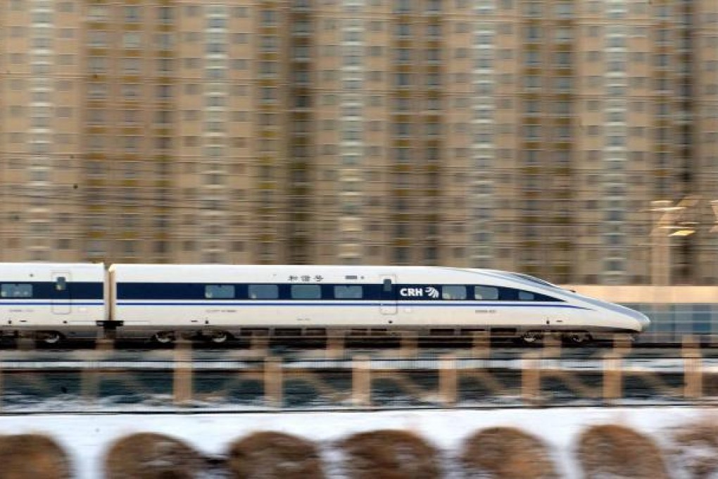 A train rushes through Beijing during a trial run for the media before the launch of the world's longest high-speed railway. Photo: Xinhua