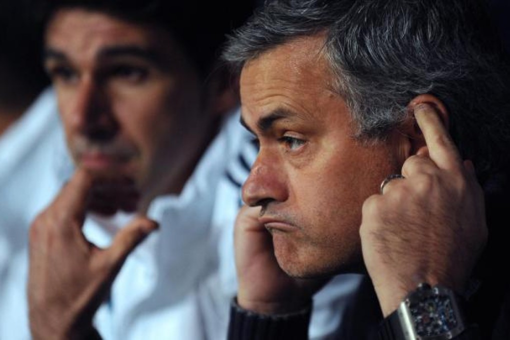 Real Madrid's embattled coach Jose Mourinho appears to be blocking out the mocking of the fans as his side, without the dumped Iker Casillas, go down to Malaga. Photo: AFP