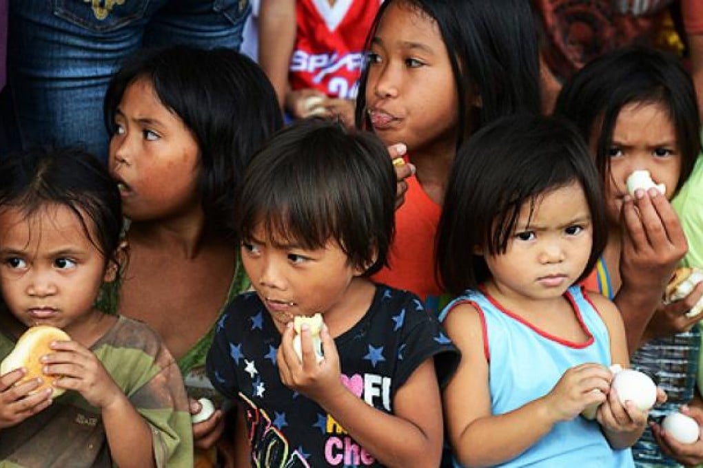 Children eating boiled eggs at an evacuation centre in Poblacion, in the southern Philippines, this month. Photo: EPA