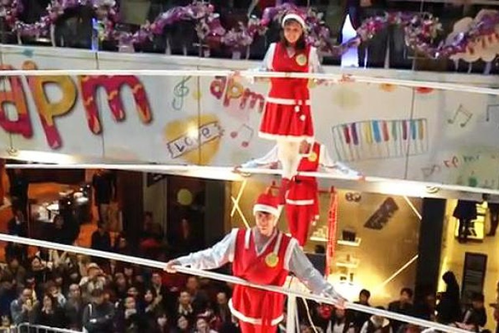 Height of excitement: tightrope walkers enthral Christmas shoppers