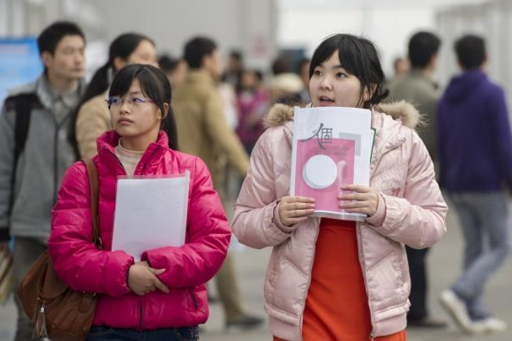 University students hunt for suitable jobs with resumes at hand during a job fair in Chongqing. Photo: Xinhua
