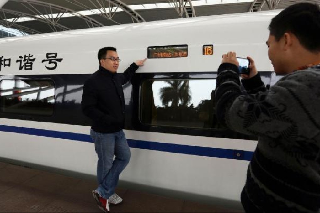 Passengers capture the moment as they arrive to board the high-speed train for its first trip on the new route from Beijing to Guangzhou yesterday, with the journey expected to take eight hours. Photo: AFP