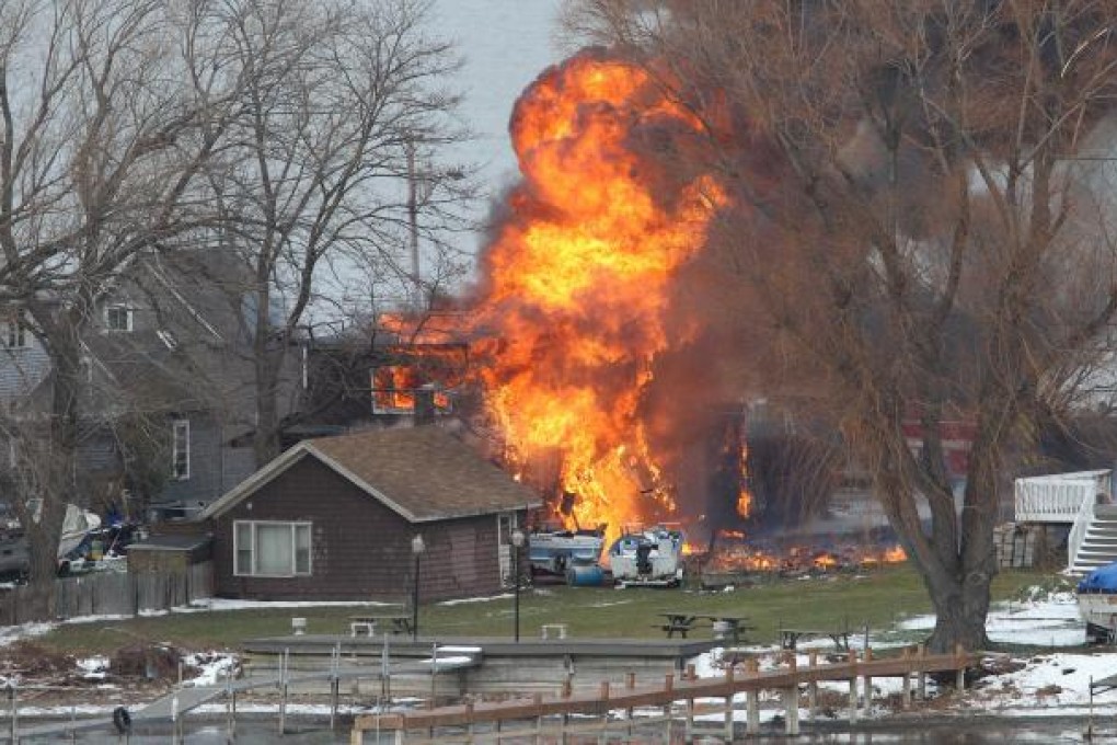 Houses ablaze after Spengler set fires and killed firemen. Photo: AP