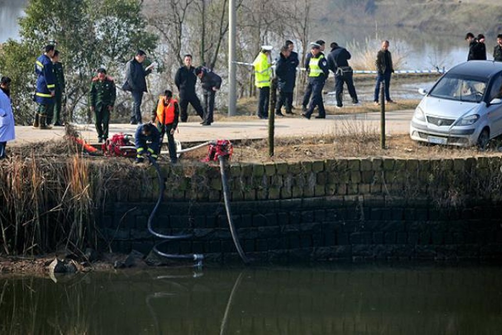 Rescuers search for missing children at the bank of a pond in Guixi, Jiangxi province, on Monday. Photo: AP