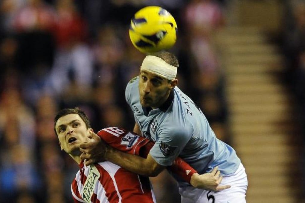 City's Pablo Zabaleta beats Adam Johnson. Photo: Reuters