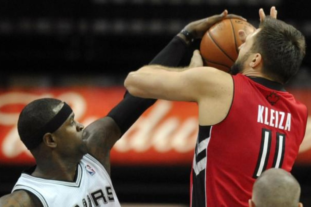 The Spurs' Stephen Jackson stops a shot from the Raptors' Linas Kleiza. Photo: AP