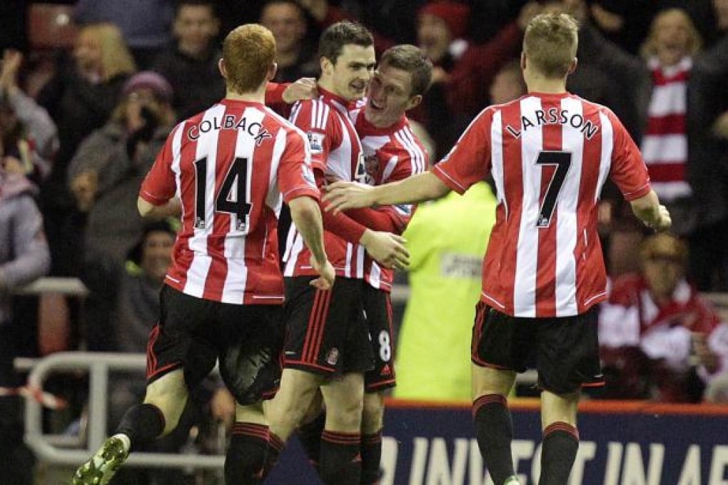 Sunderland players celebrate after midfielder Adam Johnson (second left) scores the opening goal against Manchester City. Photo: AFP