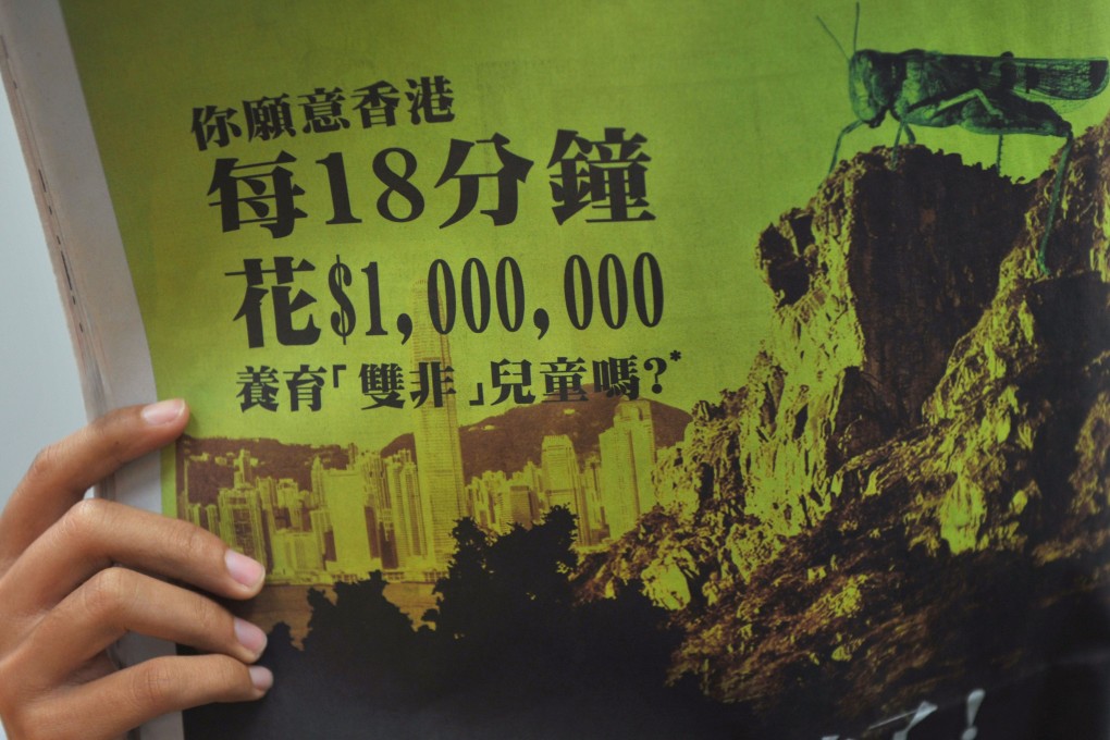 An anti-mainland China advertisement is seen on a copy of the Apply Daily newspaper in Hong Kong on February 1, 2012. Photo: AFP