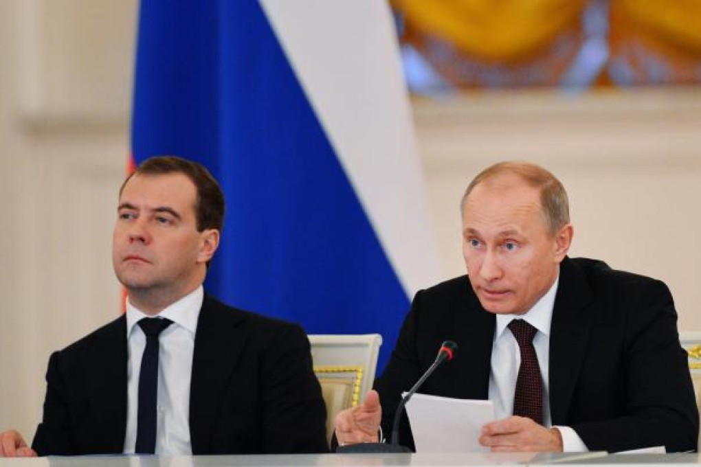 Russian President Vladimir Putin (right) speaks alongside Prime Minister Dmitry Medvedev during a State Council meeting at the Kremlin. Photo: EPA