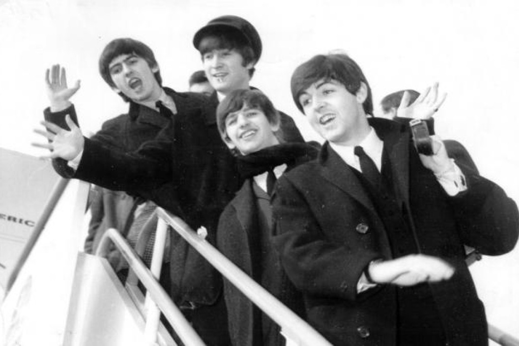 The Beatles arrive in the US for their first visit in 1964.