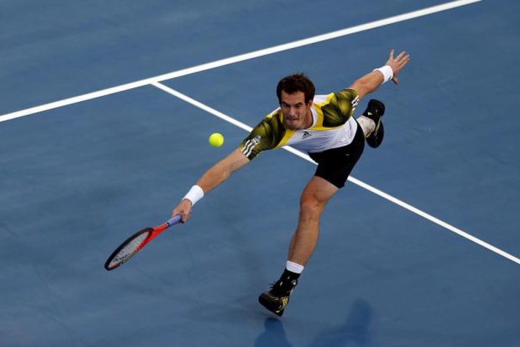 Andy Murray at full stretch with a forehand to hit a return to Janko Tipsarevic during their match in Abu Dhabi on Thursday. Photo: AFP