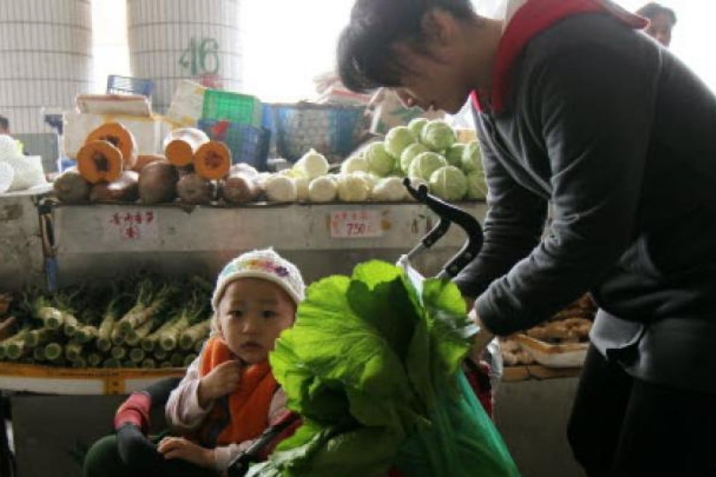 A shenzhen mother with her child in a local supermarket. Photo: Oliver Tsang/SCMP