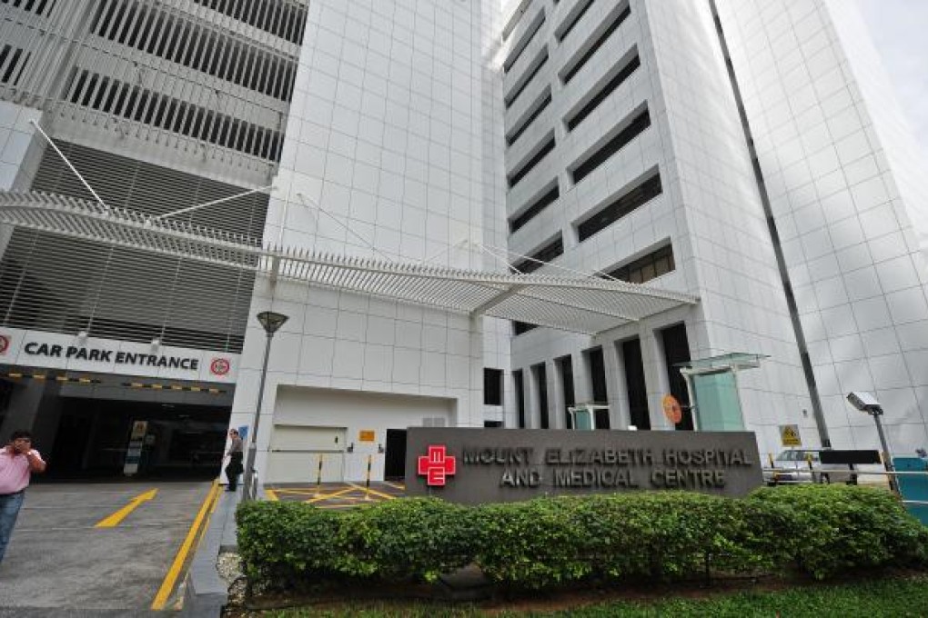 Pedestrians walk past Mount Elizabeth Hospital where the victim of a horrifying gang rape from India is seeking medical treatment. Photo: Xinhua