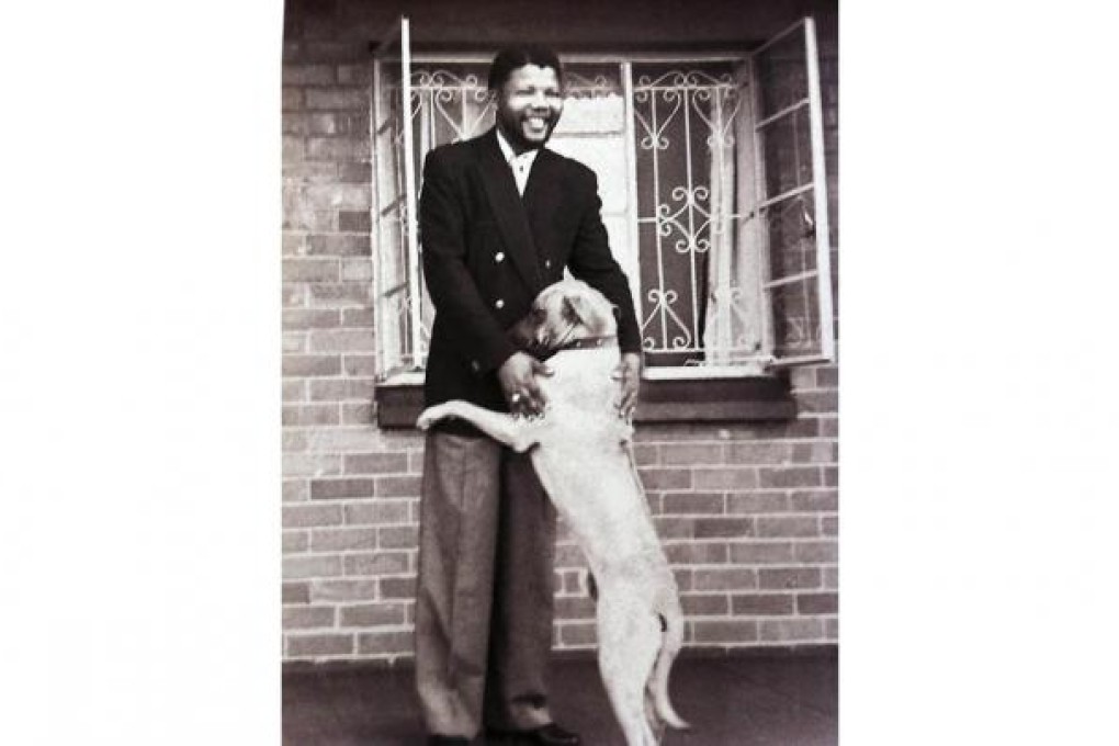 Nelson Mandela enjoys an encounter with a dog.