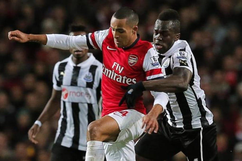 Arsenal's hat-trick hero Theo Walcott battles for possession with Newcastle's Cheik Ismael Tiote at the Emirates. Photo: EPA