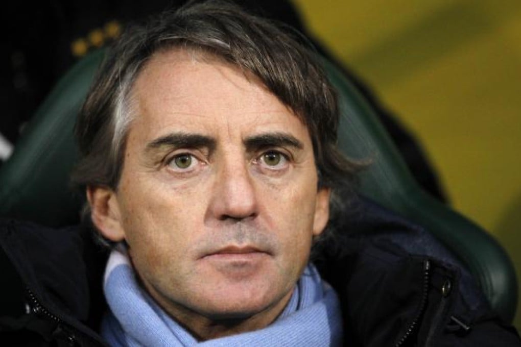 Manchester City coach Roberto Mancini, unhappy with the decision of referee Mike Jones to show Samir Nasri a red card on Saturday. Photo: AFP