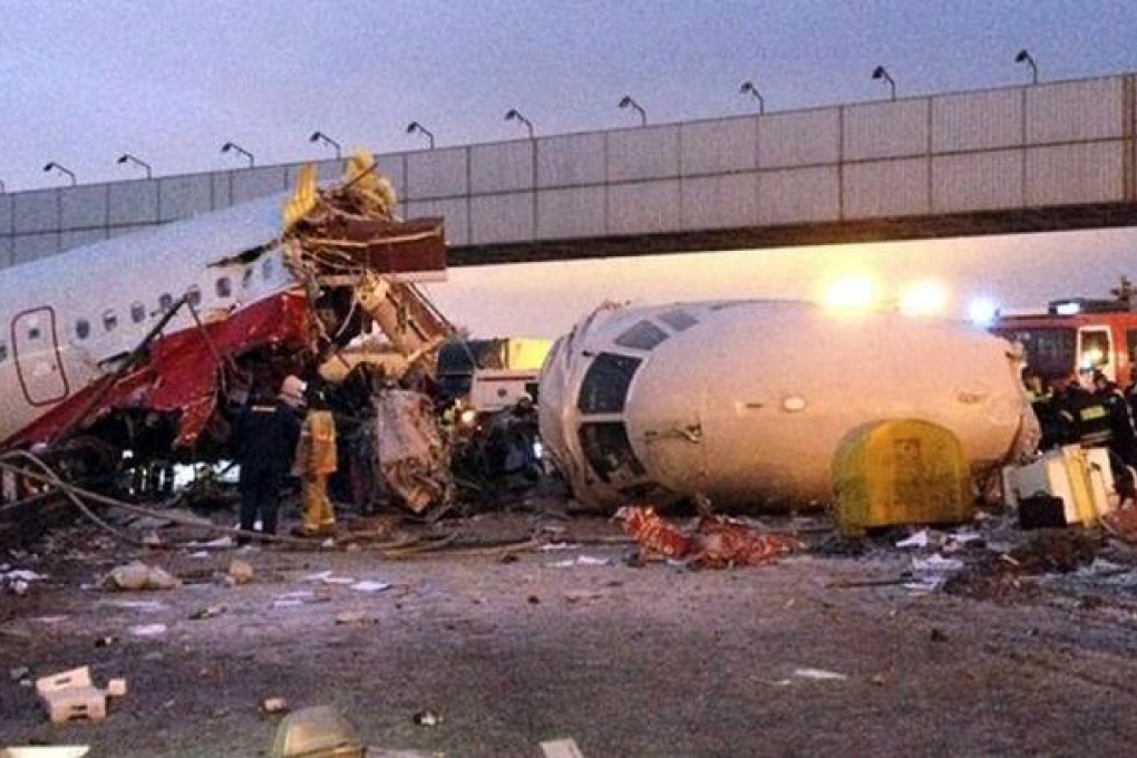 Russian police investigators and emergency services teams work at the Tu-204 jet crash site. Photo: AFP