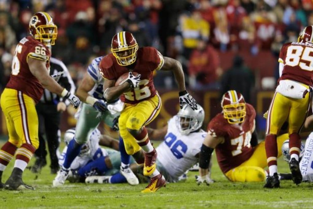Washington running back Alfred Morris rushes through the Dallas defence in the Redskins victory, which sealed the NFC East title. Photo: AFP