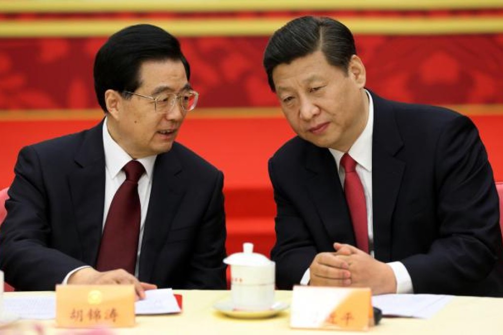 Hu Jintao (left) and Xi Jinping chat yesterday. Photo: Xinhua