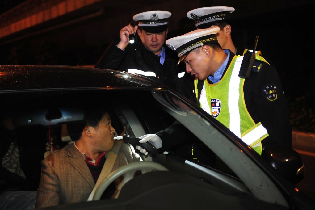 Shenzhen police give an alcohol test to a motorist as new traffic rules come into effect. Photo: Xinhua