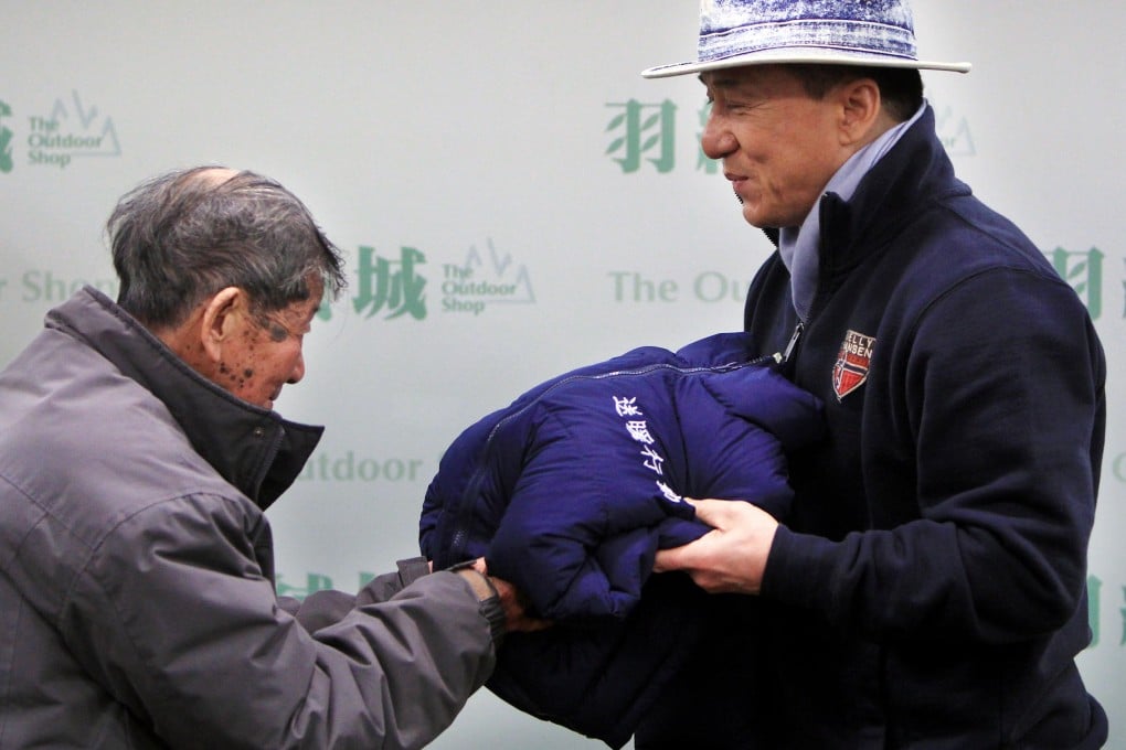 Jackie Chan does his bit for charity yesterday. Photo: Jonathan Wong