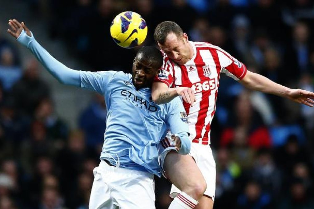 Manchester City's Yaya Toure and Stoke City's Charlie Adam battle for the ball during their English Premier League match at Etihad. Toure may be away for six weeks at the Africa Cup of Nations. Photo: Reuters