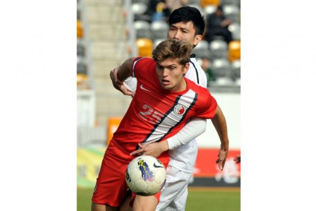 Hong Kong's Jamies McKee shields the ball. Photo: Xinhua
