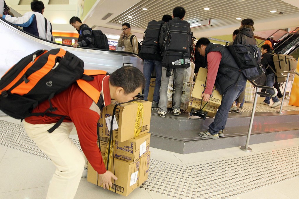 Commuters lugging hefty cargoes are becoming a common sight at Tai Wo station after Sheung Shui saw multiple raids. Photo: Edward Wong