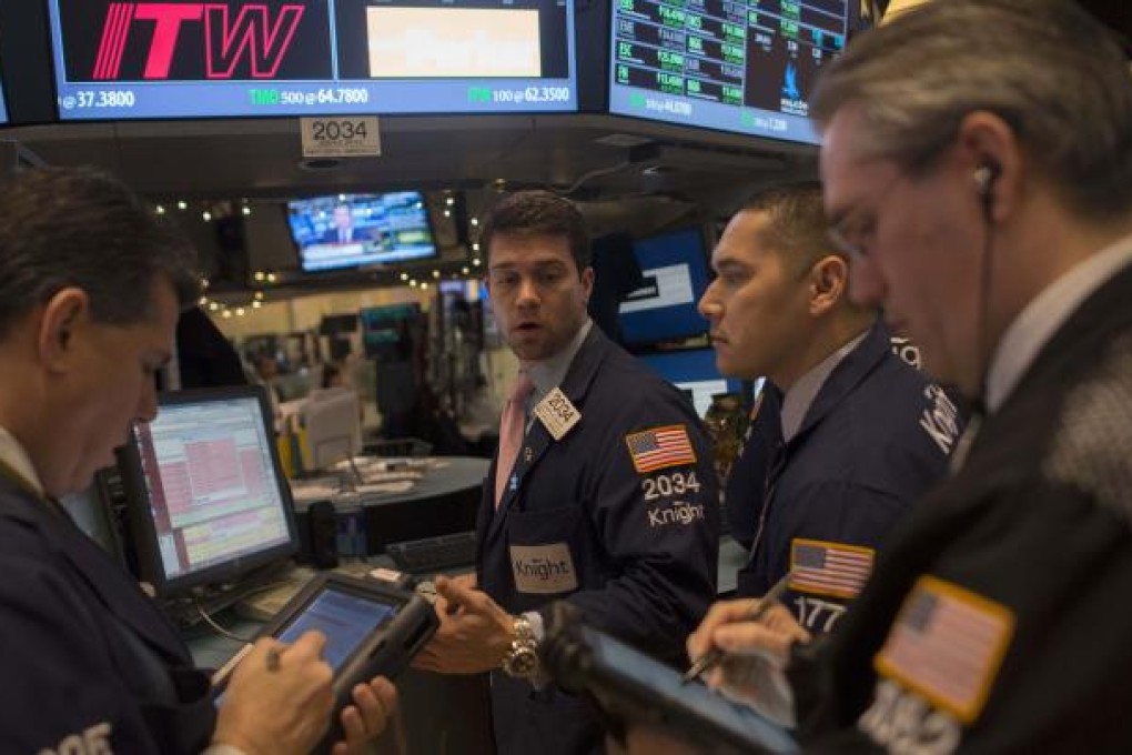 Traders work on the floor of the New York Stock Exchange yesterday as stocks soared on news of the last-minute budget deal. Photo: Reuters