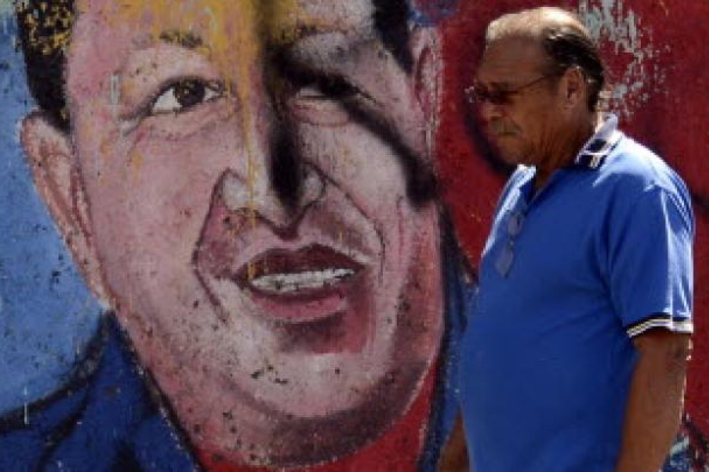 A man walks past a mural of Venezuelan President Hugo Chavez in Caracas. Chavez on Wednesday was said to be in “stable”, but still delicate condition. Photo: AP