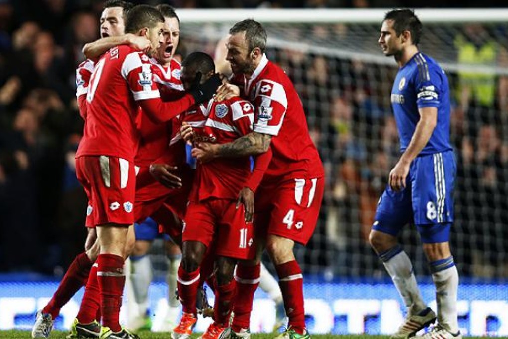 Shaun Wright-Phillips is mobbed by his teammates after scoring against Chelsea. Photo: Xinhua