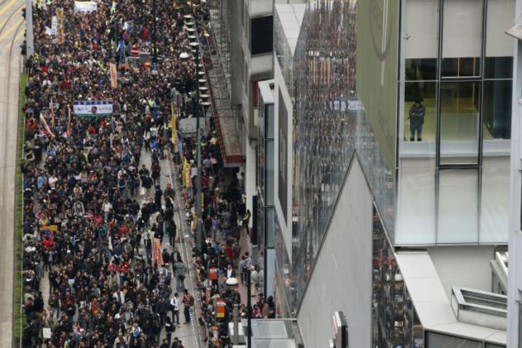 Thousands of anti-government protesters march to the government's headquarters on New Year's Day to call for the resignation of Hong Kong's Chief Executive Leung Chun-ying. Photo: AP