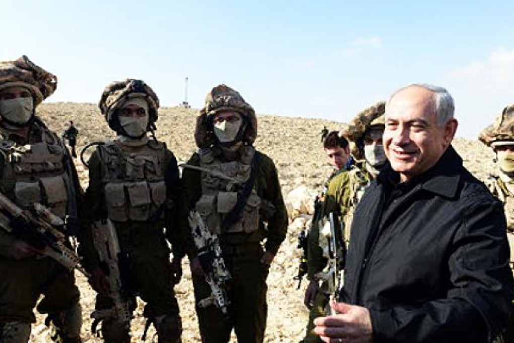 Israeli Prime Minister Benjamin Netanyahu (right) with Israeli soldiers. Israel says it plans to step up arrests of suspected militants in the occupied West Bank to prevent further unrest. Photo: EPA