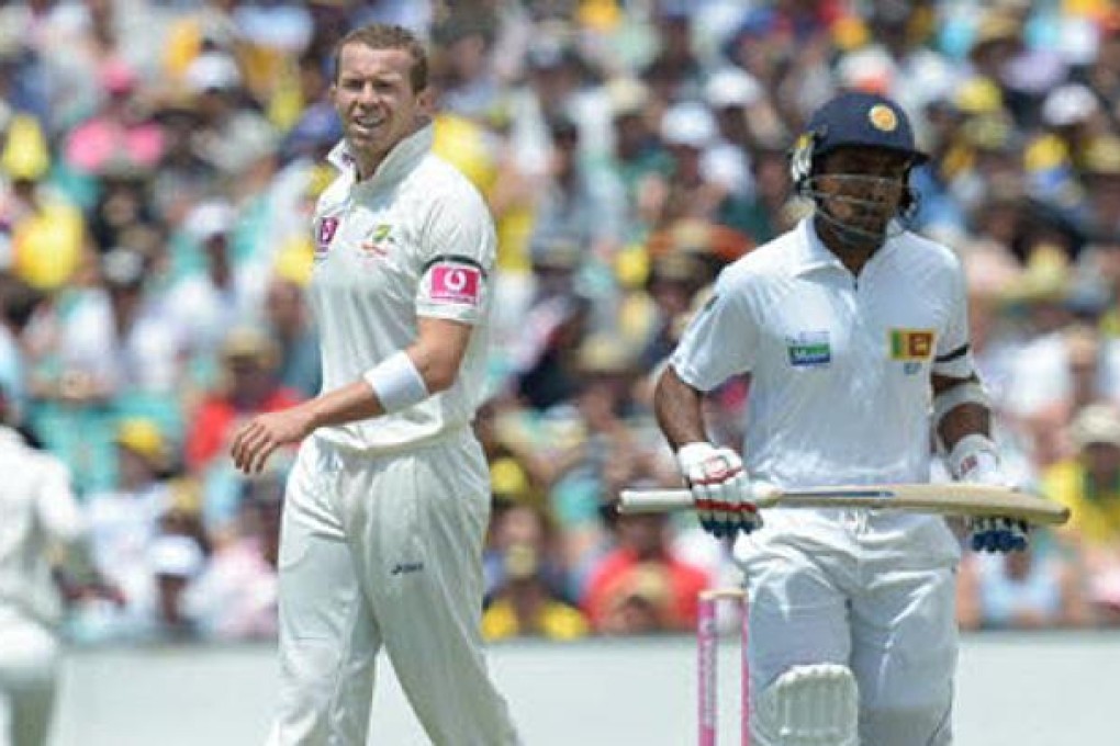 Australia's Peter Siddle reacts after being hit for four by Sri Lanka's Mahela Jayawardene on day one of the sixth test, Australia v Sri Lanka in Sydney on Thursday. Photo: EPA