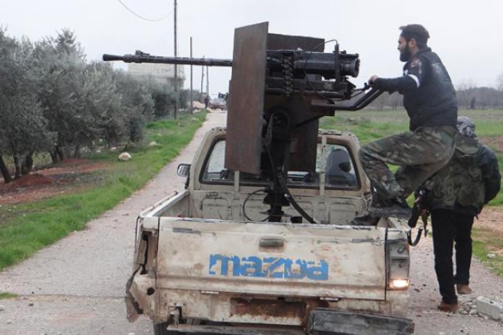 Free Syrian Army fighters are seen with weapons at the front line near a military air base loyal to Syria's President Bashar al-Assad at Taftanaz. Photo: Reuters