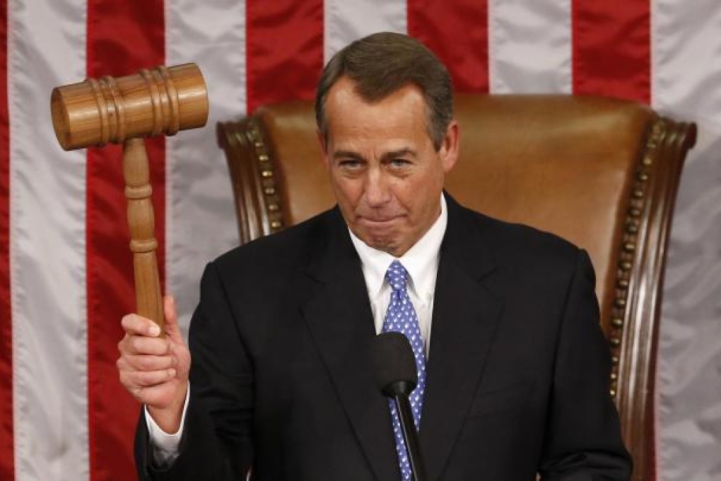 Speaker of the House John Boehner holds up the gavel of authority after being re-elected on the first day of the 113th Congress. Photo: Reuters
