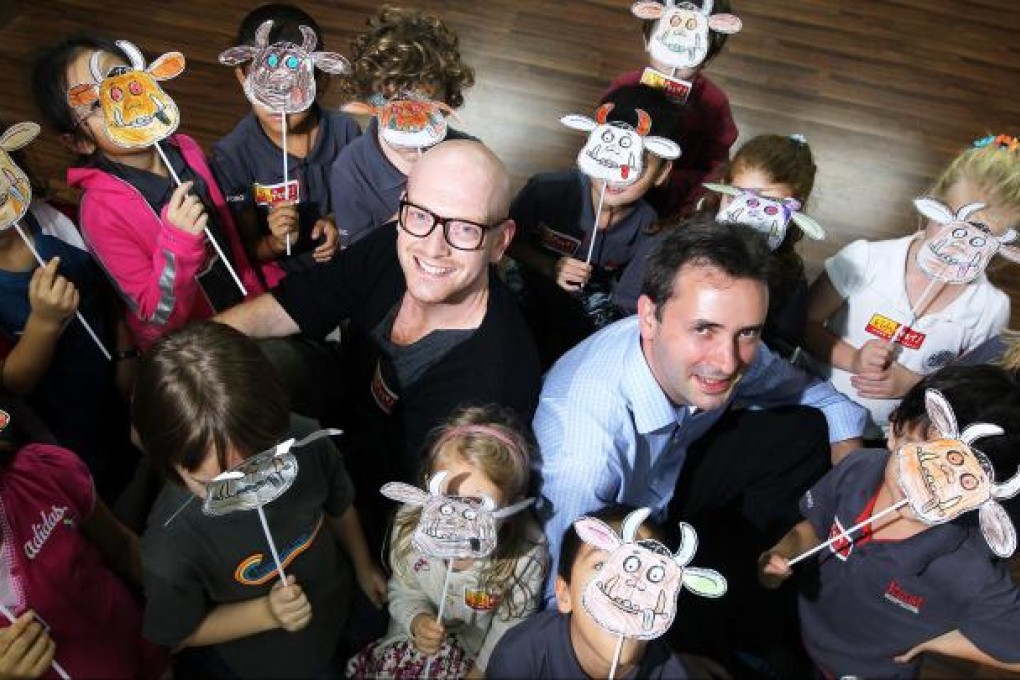 Matthew Gregory (right), executive producer ABA Productions, and actor James Gitsham rehearse with children in a theatre in Sheung Wan. Photo: Felix Wong