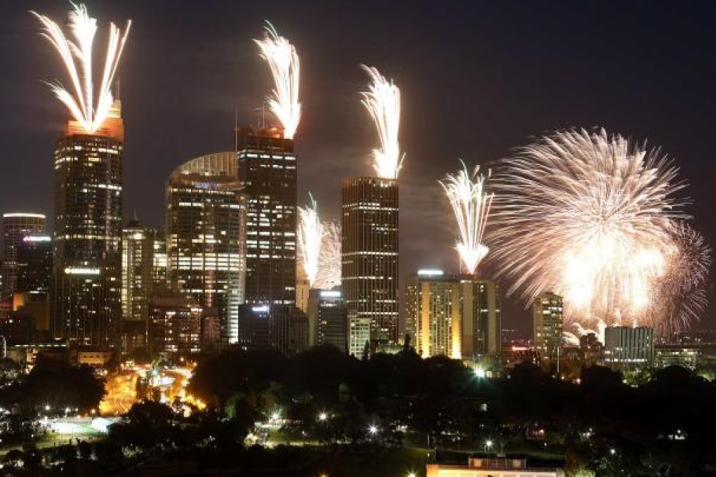 Fireworks explode on the rooftops of buildings in the Sydney during a show prior to the new year celebrations on December 31, 2012. Photo: Reuters